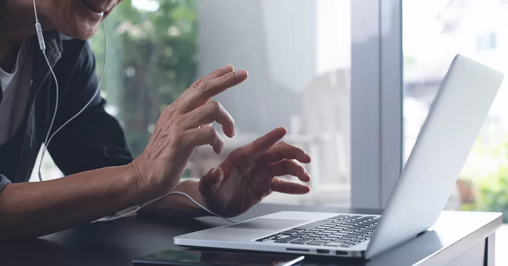 This article is about an online report launch surrounding Ireland's mpox response. The image shows a man engaging in a virtual call on his laptop.