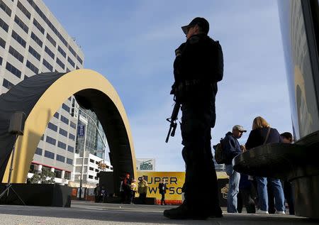 An armed police stands watch near a Super Bowl 50 attraction in down town San Francisco, California February 4, 2016. REUTERS/Mike Blake