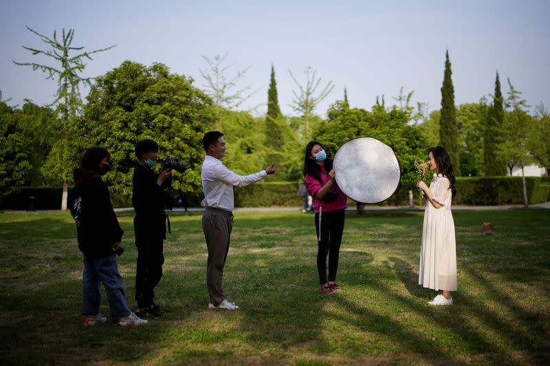 Peng Jing, 24, and Yao Bin, 28, pose for their wedding photography shoot after the lockdown was lifted in Wuhan