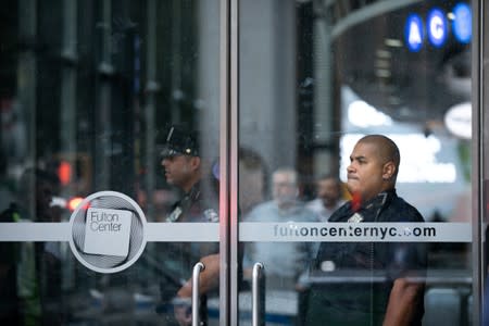 New York City Police Department officers are seen near the Fulton Street subway station as police said they were investigating two suspicious packages in Manhattan