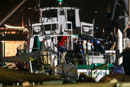 FILE PHOTO: Rescue personnel return to shore with the victims of a pre-dawn fire that sank a commercial diving boat off the coast of Santa Barbara, California