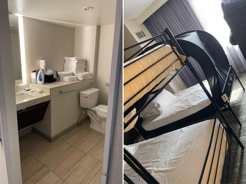 There's a typical hotel bathroom with a shower and toilet and familiar white, crisp sheets.