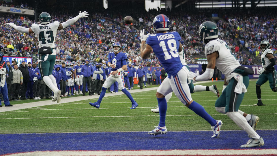 New York Giants quarterback Daniel Jones (8) completes a pass to wide receiver Isaiah Hodgins (18) for a touchdown against the Philadelphia Eagles during the second quarter of an NFL football game, Sunday, Dec. 11, 2022, in East Rutherford, N.J. (AP Photo/Bryan Woolston)