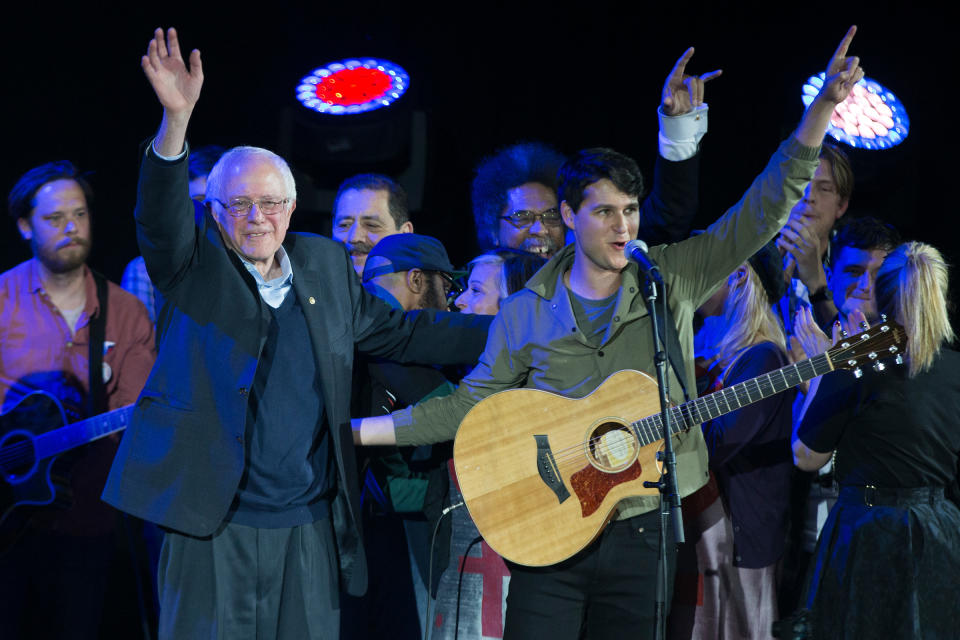 Democratic presidential candidate Sen. Bernie Sanders, and Vampire Weekend lead singer Ezra Koenig wave during a campaign rally at the University of Iowa on Jan. 30, 2016 | Evan Vucci—AP