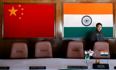 FILE PHOTO: A man walks inside a conference room used for meetings between military commanders of China and India, at the Indian side of the Indo-China border at Bumla, in the northeastern Indian state of Arunachal Pradesh, November 11, 2009.  REUTERS/Adnan Abidi/File Photo