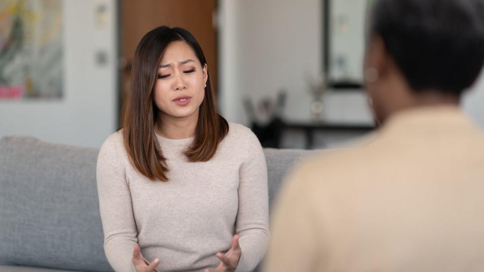 Woman speaks at financial counselling service. 