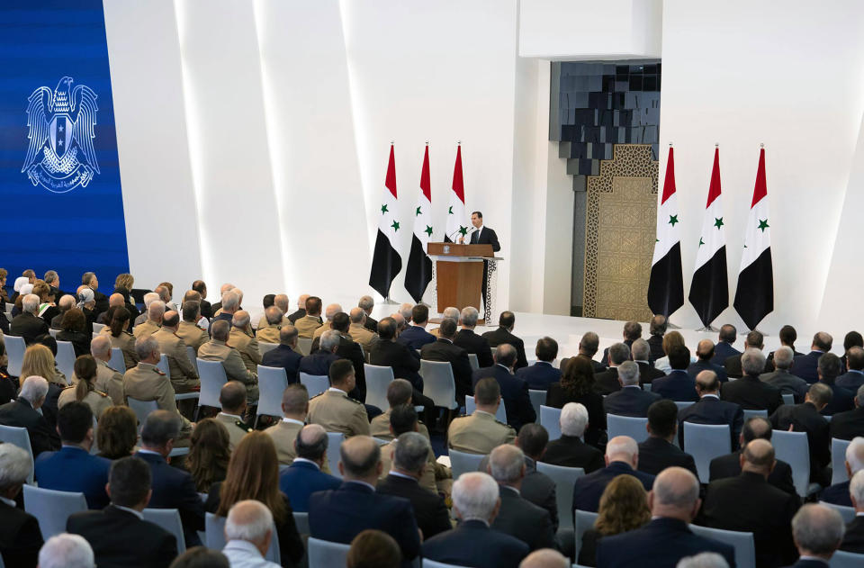 In this photo released by the official Facebook page of the Syrian Presidency, Syrian President Bashar Assad takes the oath of office for a fourth seven-year term, at the Syrian Presidential Palace in the capital Damascus, Syria, Saturday, July 17, 2021. In power since 2000, Assad's re-election in a landslide was not in doubt. His new term starts with the country still devastated by the 10-year war and sliding deeper into a worsening economic crisis. (Syrian Presidency via Facebook via AP)