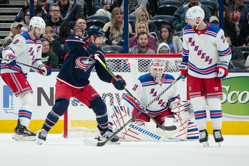 Columbus Blue Jackets center Boone Jenner (38) tips a puck in front of New York Rangers goaltender Igor Shesterkin (31) during the second period of the NHL hockey game at Nationwide Arena on April 8, 2023. 