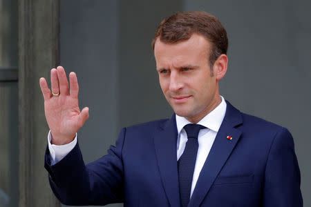 French President Emmanuel Macron waves to Italian Prime Minister Giuseppe Conte (not seen) as he leaves after a meeting at the Elysee Palace in Paris, France, June 15, 2018. REUTERS/Philippe Wojazer