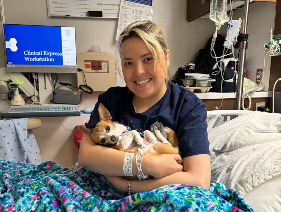 Season to Share nominee Maria Sanchez smiles during a medical visit, her faithful pup Daisy Dukes in her arms.