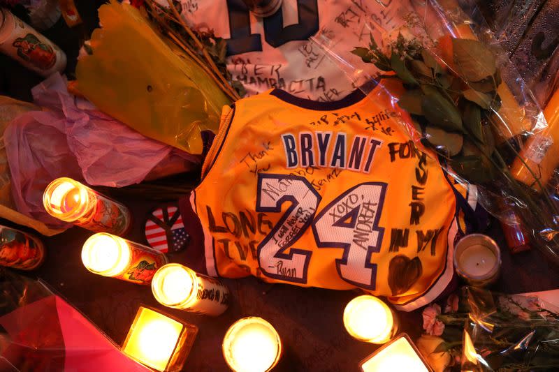 Floral and gift tributes lie outside Staples Center before a Los Angeles Lakers home game
