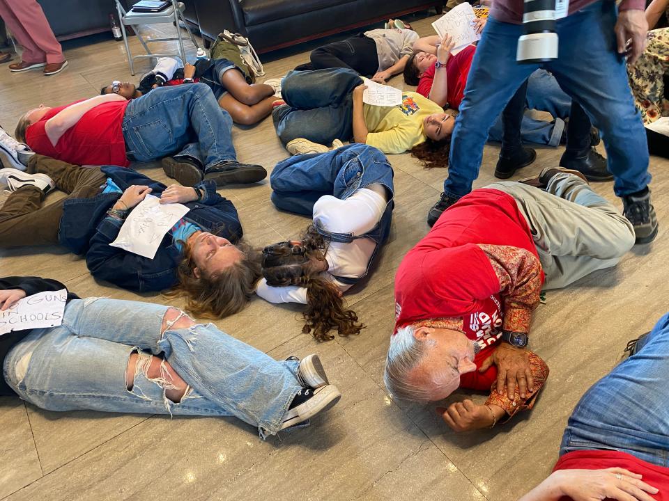 Demonstrators opposed to a bill allowing armed teachers in Tennessee schools stage a lie-in at the state Capitol after the House voted on the measure on Tuesday, April 23, 2024.