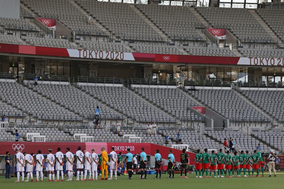 Players gather on the pitch ahead of the Tokyo 2020 Olympic Games men's group A first round football match between Japan and South Africa at Tokyo Stadium in Tokyo on July 22, 2021. (Photo by Mariko Ishizuka / AFP) (Photo by MARIKO ISHIZUKA/AFP via Getty Images)