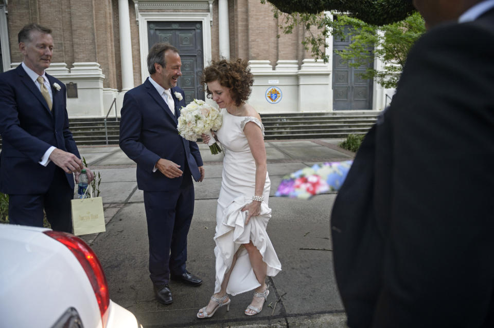 Associated Press staff photographer Gerald Herbert, second from left, and Lucy Sikes head for the limousine after being wed at Mater Dolorosa Catholic Church ahead of Tropical Storm Barry in New Orleans, Friday, July 12, 2019. Originally scheduled for Saturday, the couple moved the nuptials up a day to avoid the arrival of Barry. (Max Becherer/The Advocate via AP)