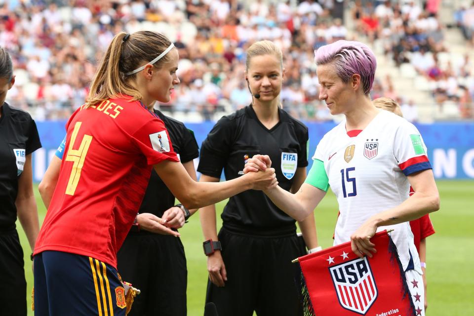Spain's Irene Paredes (left) shakes hands with USWNT star Megan Rapinoe ahead of their 2019 World Cup match.
