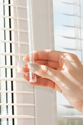 You can vacuum the dust off metal, plastic or wood blinds; but if the grime buildup just isn't coming off, try covering your hand with a (clean) old sock, dipping the tip in white vinegar and wiping the blinds -- the gunk should soon disappear.
