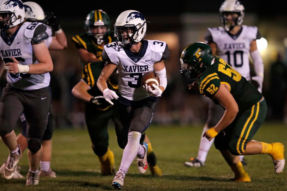 Xavier's Isaiah Des Jardins runs for a touchdown against Freedom during their football game Sept. 1 in Freedom.