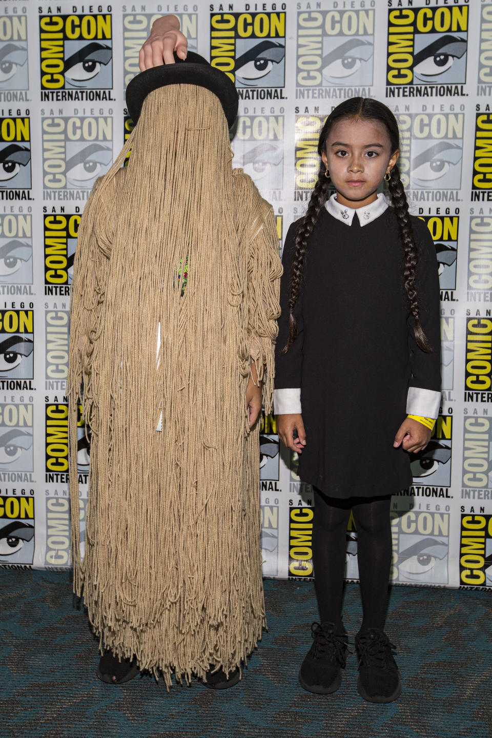 Young cosplayers Ron Pizarro (L) and Mya Pizarro dressed as Cousin It and Wednesday Addams from "The Addams Family."&nbsp;