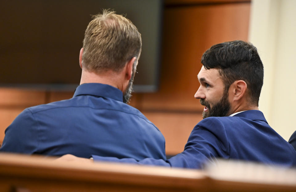 Defendants Matthew Collins, left, and Christopher "Shane" Burbank talk in the gallery during the pre-trail motion in the trial of Tacoma Police Officers Christopher Burbank, Matthew Collins and Timothy Rankine in the killing of Manny Ellis at Pierce County Superior Court Monday, Sept. 18, 2023, Tacoma, Wash. (Brian Hayes/The News Tribune via AP, Pool)