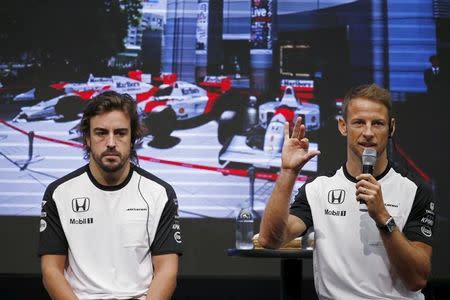 McLaren Formula One drivers Fernando Alonso (L) of Spain and Jenson Button of Britain attend a fan meeting at the Honda Motor Co's headquarters in Tokyo, Japan, September 23, 2015, ahead of Sunday's Japanese F1 Grand Prix. REUTERS/Toru Hanai