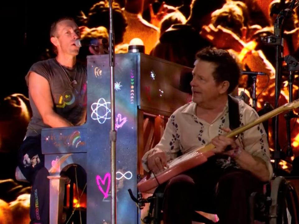 Chris Martin performs with Michael J Fox on the Pyramid Stage at Glastonbury (BBC)