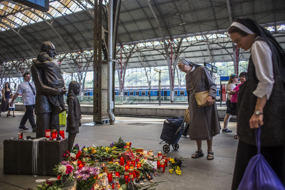 PRAGUE, CZECH REPUBLIC - JULY 02:  Nuns pay respect at the statue of Sir Nicholas Winton at the main train station on July 2, 2015 in Prague, Czech Republic. Winton saved 669 mostly Jewish children by organising their escape from occupied Czechoslovakia to Great Britain, earning him the nickname the 'British Schindler'. Nicolas Winton died aged 106 on July 1.  (Photo by Matej Divizna/Getty Images)