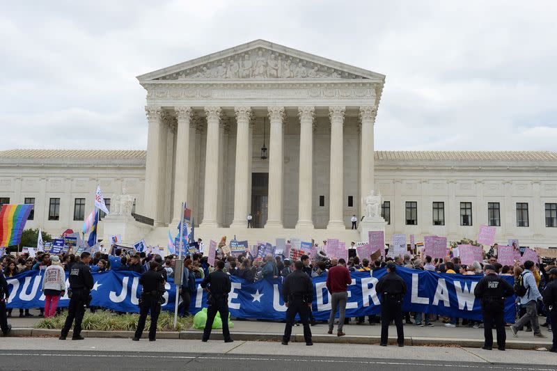 FILE PHOTO: LGBTQ activists and supporters hold rally on the steps of the Supreme Court as it hears major LGBT rights case