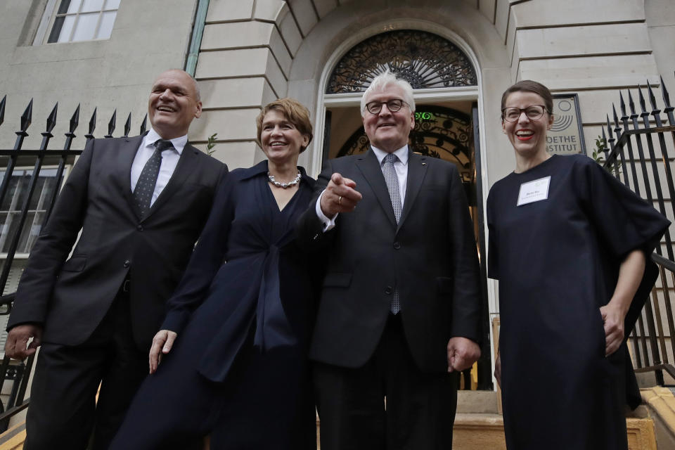 German President Frank-Walter Steinmeier, second from right, poses for a photo with his wife, Elke Budenbender, left, and Goethe Institute Secretary General Johannes Ebert, far left, and Director of Goethe Institute Boston, Marina May, far right, on the steps of Goethe Institute, Thursday, Oct. 31, 2019, in Boston. (AP Photo/Elise Amendola)