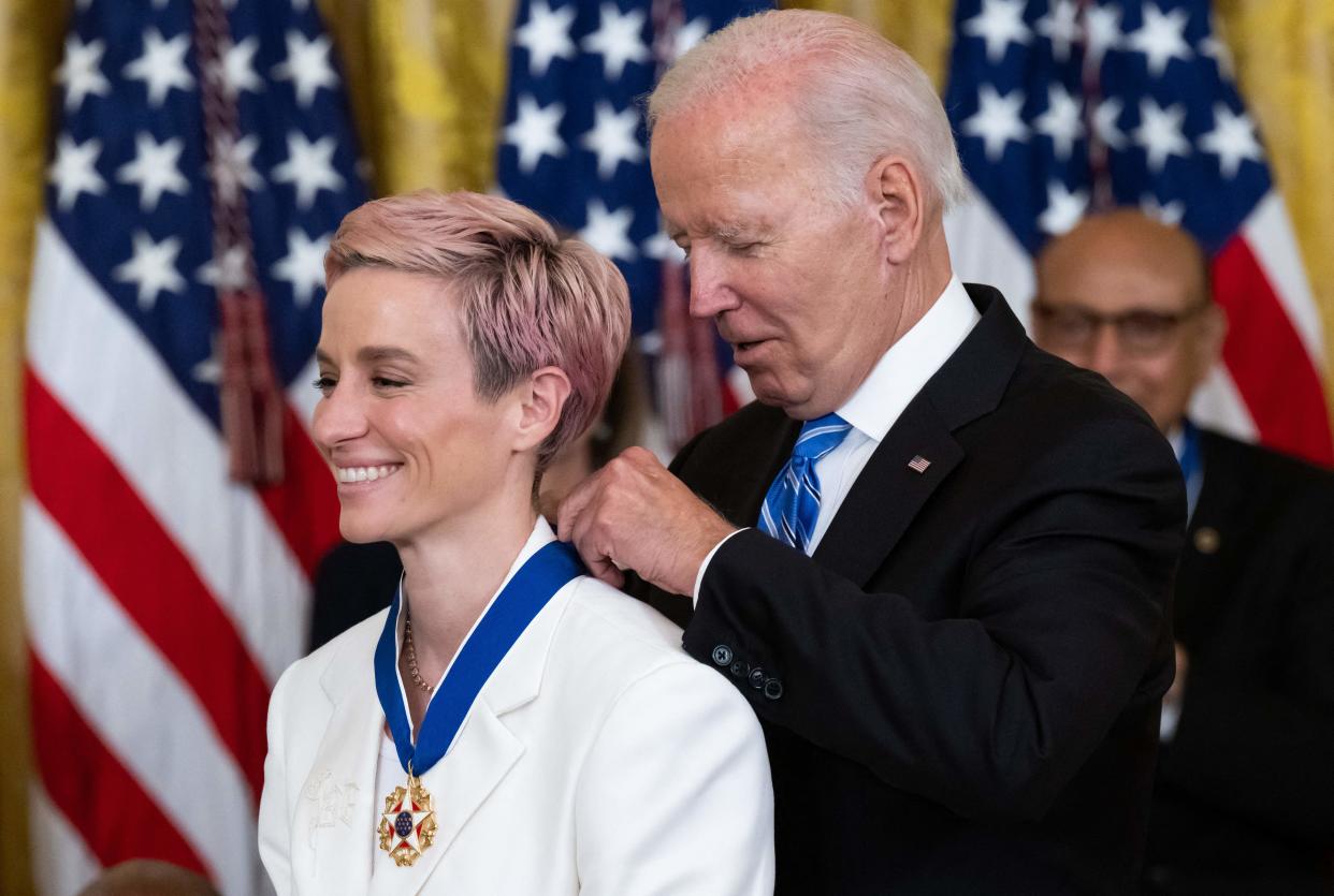 US President Joe Biden presents US soccer player Megan Rapinoe with the Presidential Medal of Freedom, the nation's highest civilian honor, during a ceremony honoring 17 recipients, in the East Room of the White House in Washington, DC, July 7, 2022. - The Suit of US soccer player Megan Rapinoe is embroidered with the initials 'BG', for WNBA player Brittney Griner, who is held in Russia (Photo by SAUL LOEB / AFP) (Photo by SAUL LOEB/AFP via Getty Images)