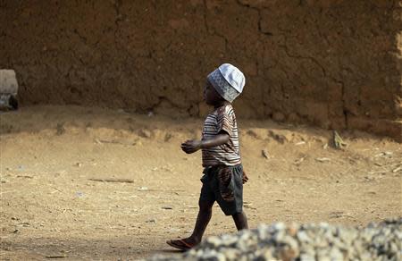 A boy walks on a street in Bakin Kogi, Zango kataf, Kaduna State, March 22, 2014. REUTERS/Afolabi Sotunde