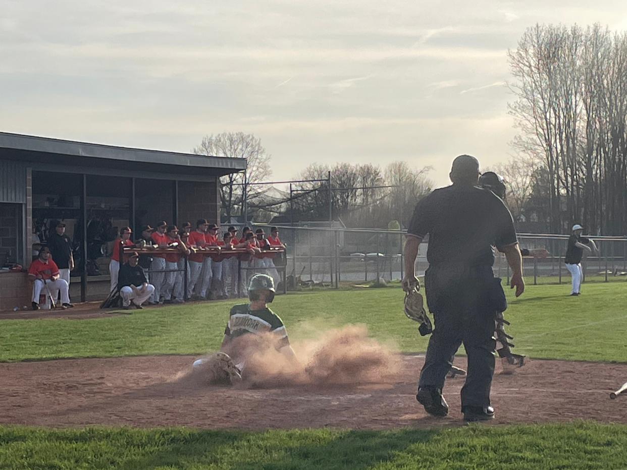 GlenOak's Bryce Broom slides into home as part of a seven-run sixth inning in the Golden Eagles' 13-2 high school baseball win at Green on Tuesday, April 16, 2024.