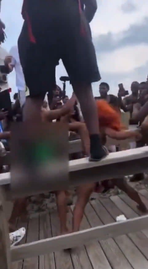 Two women throwing punches during a brawl during Orange Crush in Georgia.