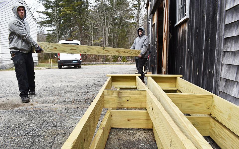 Diman Regional Vocational Technical High School carpentry students Quinton Furtado and Adam Allison move bog bridges they built for hiking trails, at 2929 Blossom Road in Fall River. The bridges will be placed in the Southeastern Massachusetts Bioreserve.