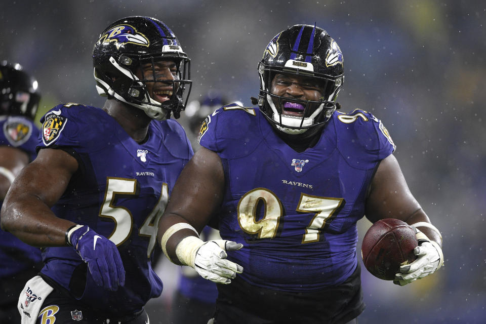 Baltimore Ravens defensive tackle Michael Pierce (97) celebrates his fumble recovery with linebacker Tyus Bowser (54) during the first half of an NFL football game against the Pittsburgh Steelers, Sunday, Dec. 29, 2019, in Baltimore. Steelers quarterback Devlin Hodges fumbled the ball on a strip sack by Ravens outside linebacker Matt Judon. (AP Photo/Nick Wass)