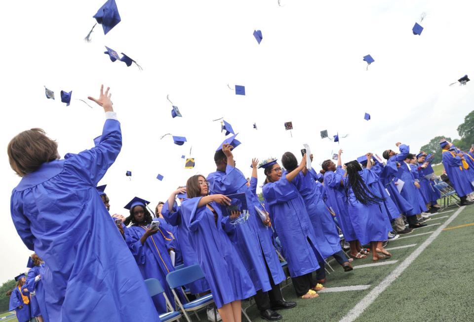 Graduates toss their caps during the Blue Hills Regional Technical School graduation in Canton, Tuesday, June, 6, 2023.