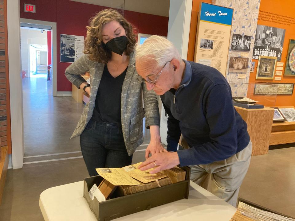 Louis Borbi and Lynne Calamia, the executive director at Roebling Museum, look over some of the employment records Borbi donated to the museum. Calamia hopes the records can be digitized so that they're searchable online.