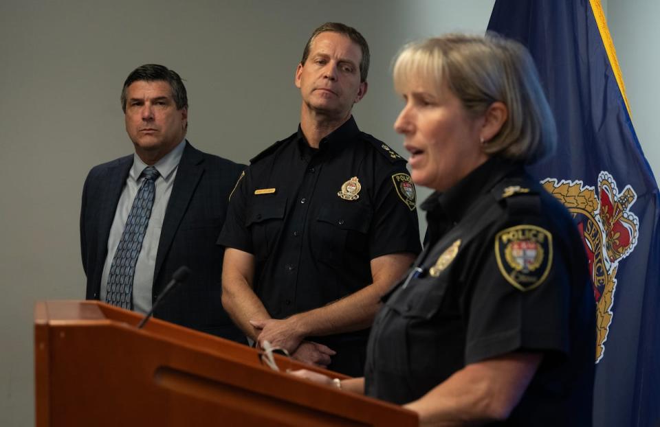 Ottawa Police Service Chief Eric Stubbs, centre, and Supt. Jamie Dunlop look on as Deputy Chief Trish Ferguson speaks during a news conference on Sept. 6, 2023.