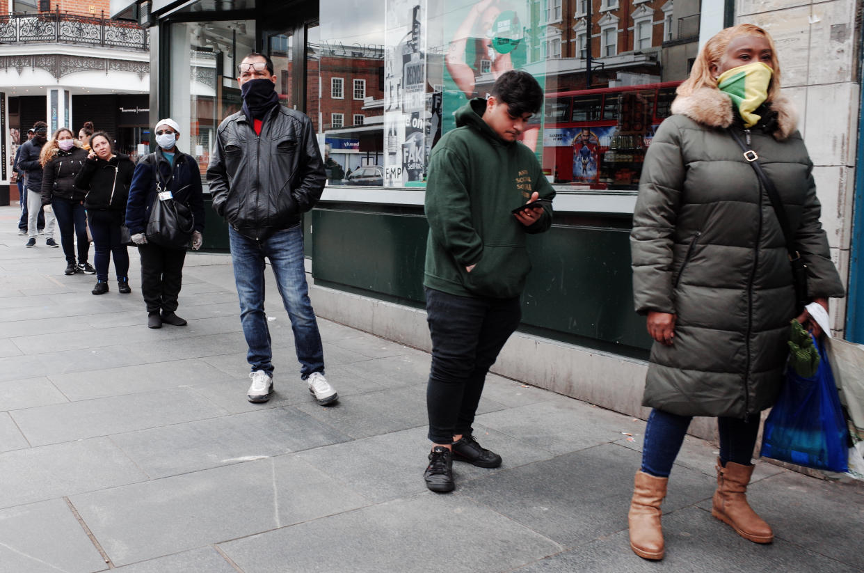 People wearing masks observe 'social distancing' guidelines while queueing to enter a supermarket on Brixton Road at Brixton in the borough of Lambeth in London, England, on April 1, 2020. Official figures report that Lambeth currently has 418 recorded cases of the covid-19 coronavirus, higher than any other local authority district in London and fourth among local authorities in England as a whole (behind Sheffield, Hampshire and Birmingham). The borough was previously trailing the neighbouring south London district of Southwark, which remains similarly hard-hit, currently with 415 cases. (Photo by David Cliff/NurPhoto via Getty Images)