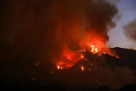 <p>Flames flare up from a wildfire near Placenta Canyon Road. (AP Photo/Ringo H.W. Chiu)<br></p>