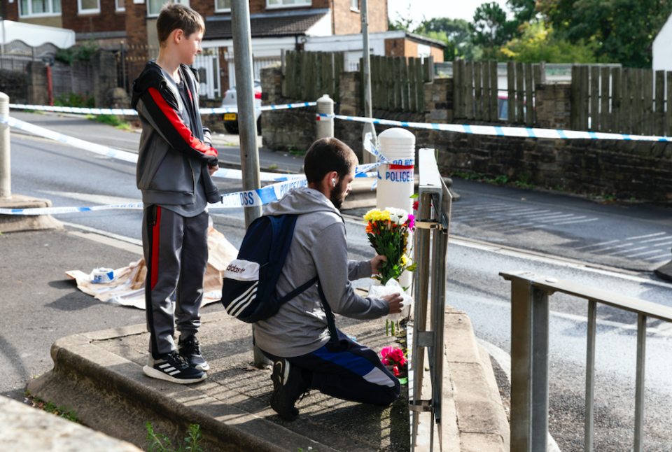 Tributes have been left at the scene of the stabbing outside the school in Huddersfield.(SWNS)