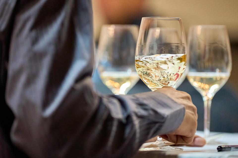 A wine judge swirls a white wine during the 2023 azcentral Arizona Wine Competition on Feb. 27, 2023, at The Newton in Phoenix.