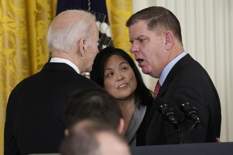 President Joe Biden talks with outgoing Labor Secretary Marty Walsh, right, after Biden announced his nomination of Julie Su, center, to serve as the Secretary of Labor, during an event in the East Room of the White House in Washington, Wednesday, March 1, 2023. (AP Photo/Susan Walsh)