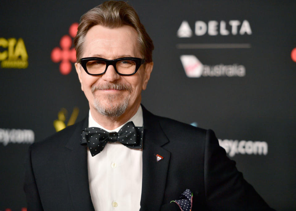 Gary Oldman attends the 7th AACTA International Awards in a suit, polka dot bowtie, and eyeglasses