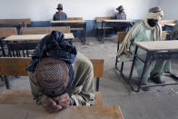 <p>A group of men detained for suspected Taliban activities are held for questioning at a schoolhouse in the village of Kuhak in Arghandab District, north of Kandahar July 9, 2010. (Photo: Bob Strong/Reuters) </p>