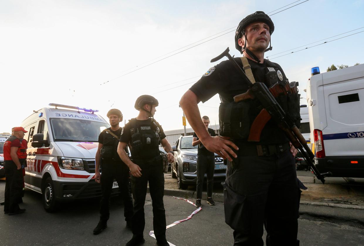 Ukrainian policemen keep watch outside, after an explosion at the Shevchenkiv District Court, in Kyiv (EPA)