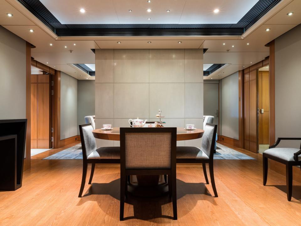 A dining room with a few dining chairs surrounding a table.