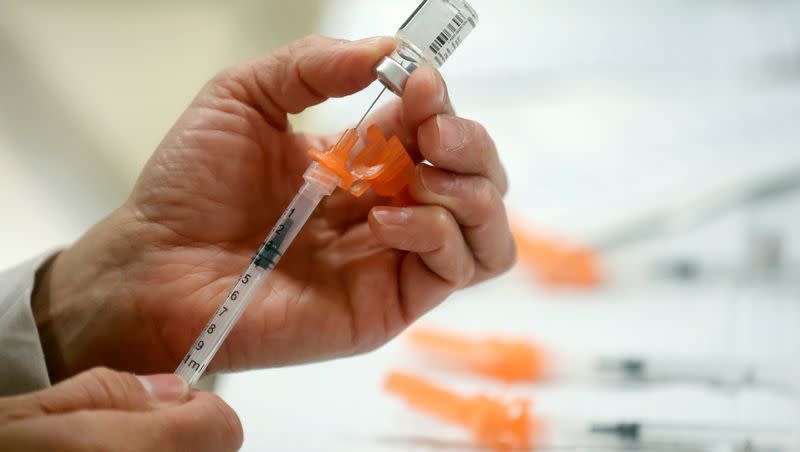 A Salt Lake County Health Department employee prepares Pfizer COVID-19 booster shots at a free vaccine clinic at the Sanderson Community Center in Taylorsville on Wednesday, Nov. 9, 2022.