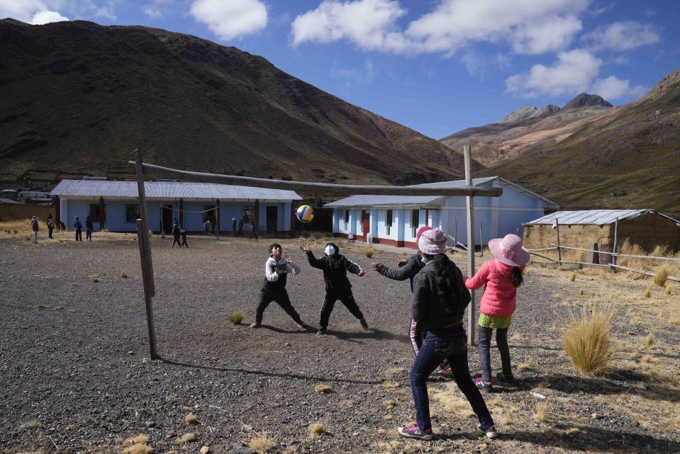Students play volleyball during recess at a bilingual public primary school in Licapa, Peru, Wednesday, Sept. 1, 2021. In 1975, a nationalist military government turned Quechua into an official language in Peru, along with Spanish, but legal recognition did not stop discrimination against Quechua speakers, who come mostly from poor and rural areas. (AP Photo/Martin Mejia)