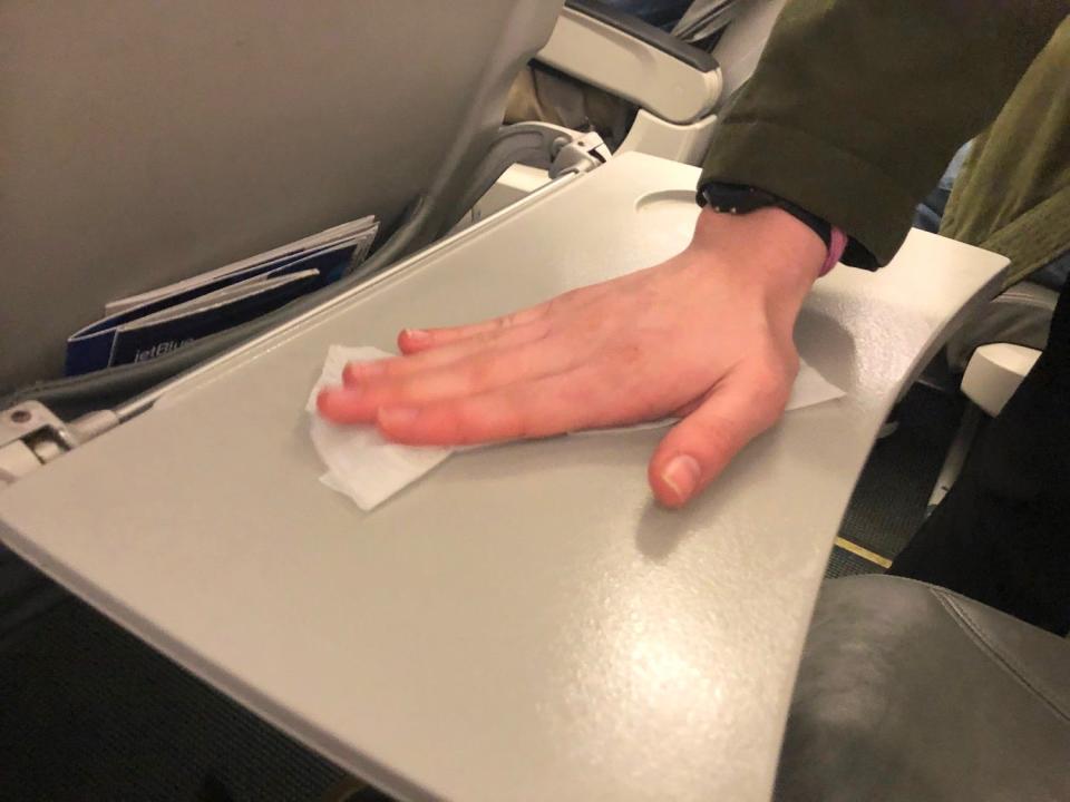 Jetblue flight during coronavirus wiping down seat