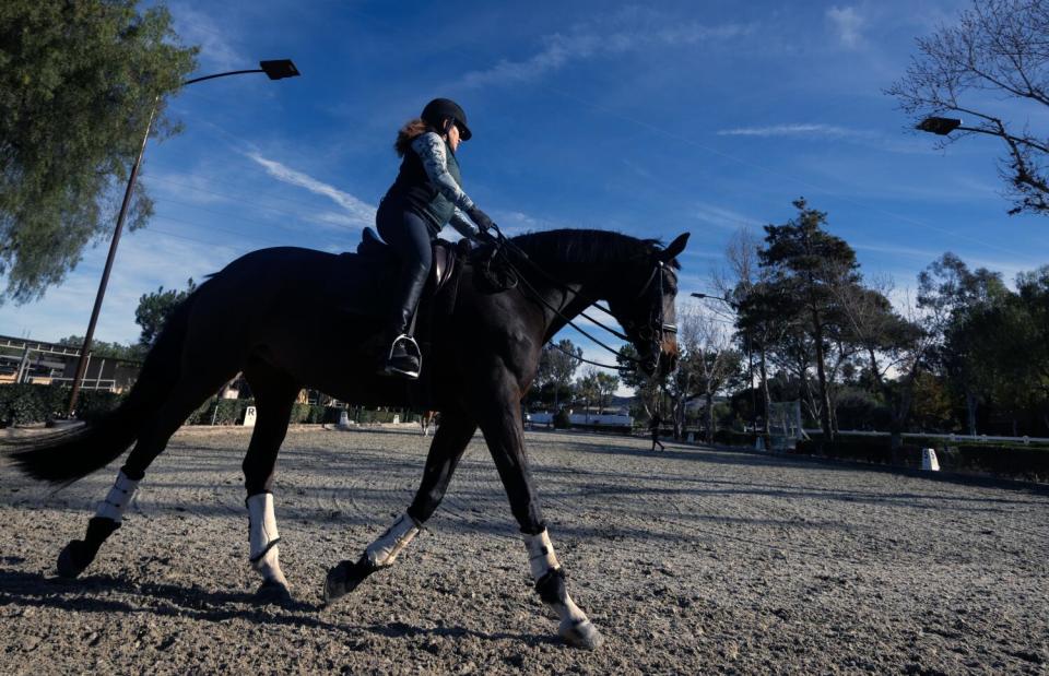 Dr. Julie Ryan Johnson riding her horse in San Juan Capistrano.